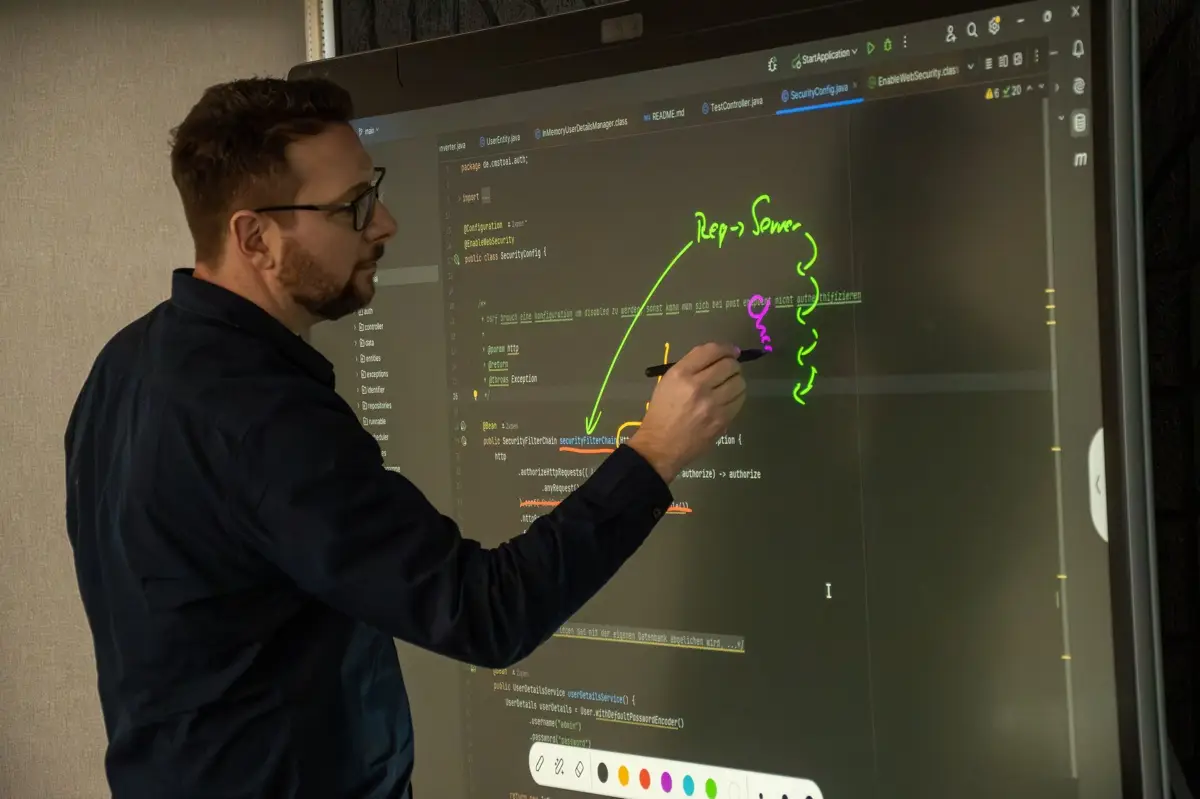 Heiko Schönemann skizziert einen Request-Server-Ablauf auf einem Touchscreen